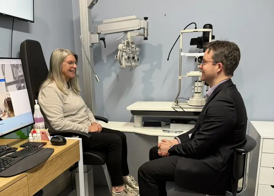 Leigh Plowman listening to a patient in the examination room