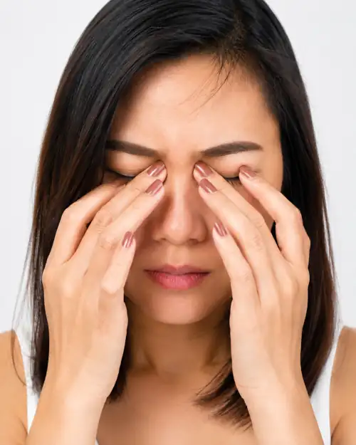 Woman rubbing her eyes due to discomfort or irritation